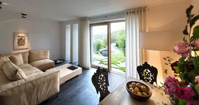 a living room with a couch and a table at Romantik Hotel Turm in Fiè