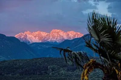 a view of a mountain range at sunset at Pension Irma in Caldaro