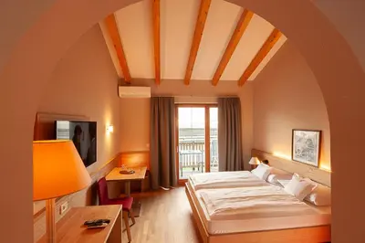 a hotel room with a bed and a window at Ansitz Waldner Oberwirt in Marlengo