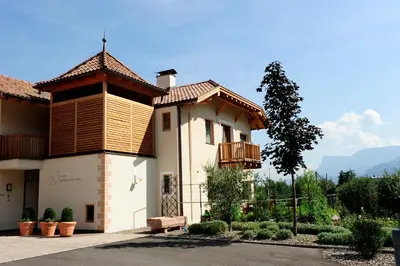 a house with a balcony on the side of it at Ansitz Waldner Oberwirt in Marlengo