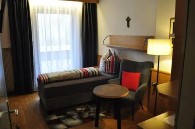 a living room with a couch and a chair and a table at Garni Schwarzenstein in Campo Tures