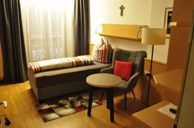 a living room with a couch and a table and a chair at Garni Schwarzenstein in Campo Tures