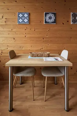 a wooden table with two chairs and a bowl on top at Apartments in Kaltern, Panorama-Terrasse mit Bergblick nahe Zentrum in Caldaro