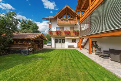 a large yard with a house with a balcony at Kienasthof in Bressanone