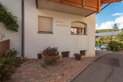 a building with a flower pot on the side of it at Kienasthof in Bressanone