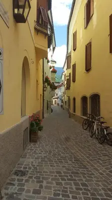 an alley with bikes parked on the side of buildings at Kienasthof in Bressanone