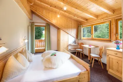 a bedroom with a large bed in a room at Hotel Wieslhof in Collepietra