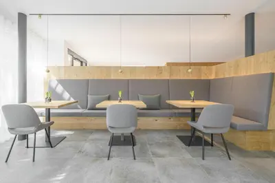 a dining room with two tables and two chairs at Hotel Kranebitt B&B in Bressanone