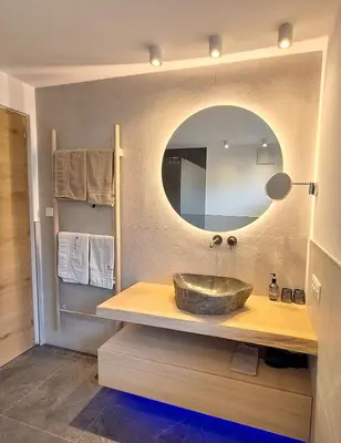 a bathroom with a sink and a mirror at Hotel Kranebitt B&B in Bressanone