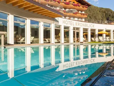 a hotel with a swimming pool in front of a building at Pitterlehof in Chienes