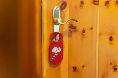 a red door knob with a mickey mouse on it at Hotel Pension Odles in San Martino in Badia