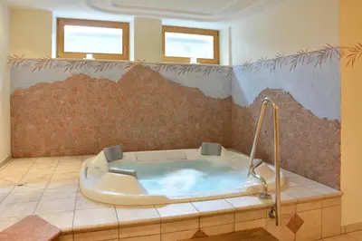 a bathroom with a bath tub in a room at Hotel Resa Blancia in San Vigilio Di Marebbe