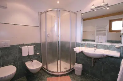 a bathroom with a shower and a sink and a toilet at Hotel Resa Blancia in San Vigilio Di Marebbe