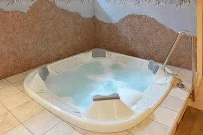 a jacuzzi tub in a room at Hotel Resa Blancia in San Vigilio Di Marebbe