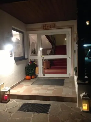 a front door of a hotel at night at Hotel Garni Lichtenau in Schenna