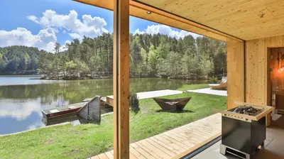 a view of a lake from the inside of a house at Hotel Weihrerhof in Soprabolzano