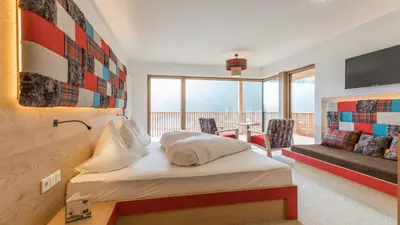 a hotel room with a bed and a balcony at Hotel Weihrerhof in Soprabolzano