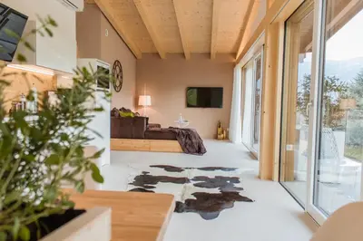 a living room with a bed and a tv at Moar Lodge in Postal