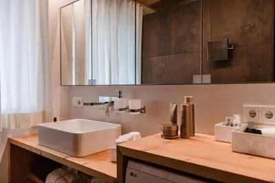 a bathroom with a white sink and a mirror at Moar Lodge in Postal