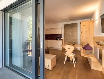 a kitchen and living room with a sliding glass door at Apartment 39012 in Merano