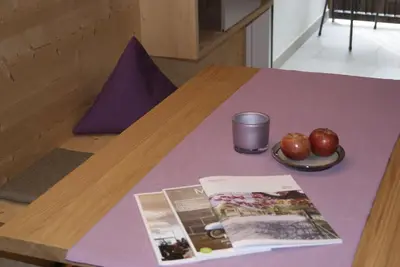 a table with a book and apples on it at Apartment 39012 in Merano