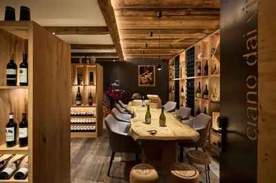 a gym with a large wall mural of a forest at Dolomites Wellness Hotel Savoy in La Villa