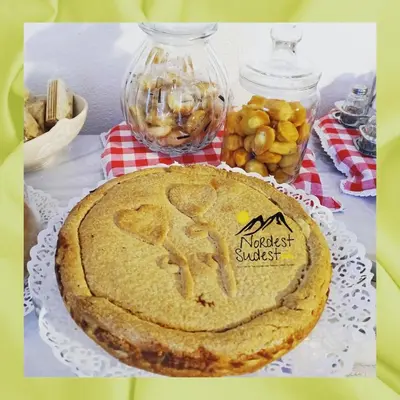 a pie sitting on a table with a plate at Camere Nordest Sudest- Conca Agordina in Agordo