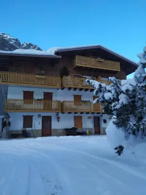 a building with flowerpots on the balconies of it at Residence Marmolada in Rocca Pietore