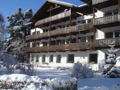 a large building with snow on the ground at Residence Perwanger in Fiè