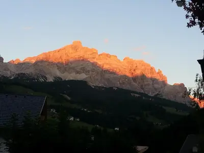 a mountain with the sun shining on it at Residence Crazzolara in La Villa