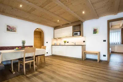 a kitchen and dining room with a table and chairs at Residence Crazzolara in La Villa