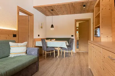 a kitchen and dining room with a table and chairs at Residence Crazzolara in La Villa
