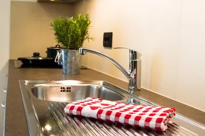 a kitchen sink with a red and white towel on it at Residence Crazzolara in La Villa