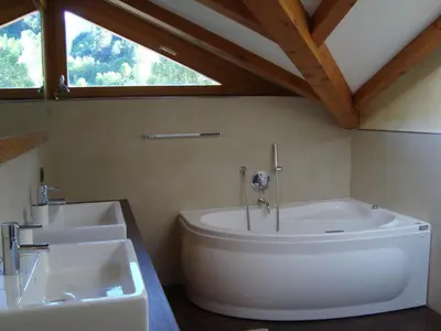 a bathroom with two sinks and a bath tub at Fiemme Deluxe Apartment in Castello di Fiemme