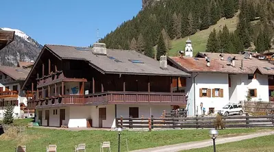 a large house in the middle of a mountain at Arnica in Canazei