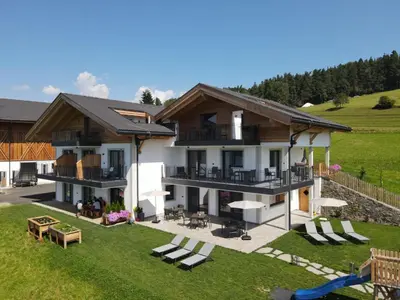 a house with a backyard with a playground at Platiederhof in Laion