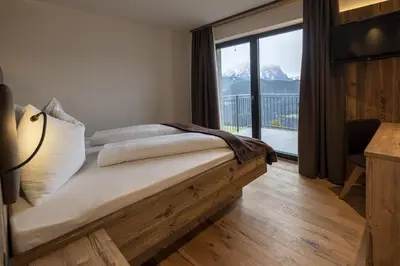 a bedroom with a bed with a view of a mountain at Platiederhof in Laion