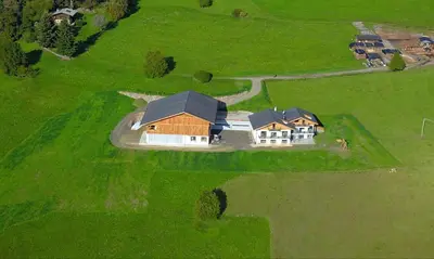 an aerial view of a house on a green field at Platiederhof in Laion
