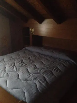 a large white bed in a room at Villa San Martino in San Martino di Castrozza
