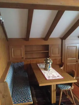 a dining room with a wooden table and chairs at Villa San Martino in San Martino di Castrozza
