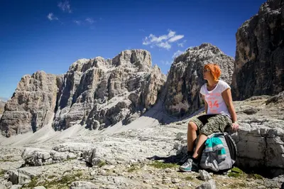 a woman sitting on a rock in the mountains at Casa Serac´ in La Valle