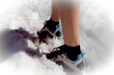 a person standing in the snow with shoes in the snow at Casa Serac´ in La Valle