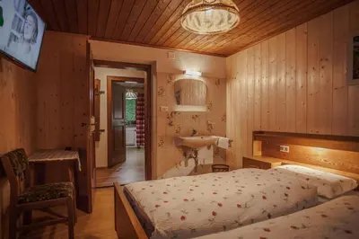 a bedroom with a bed and a sink in it at Casa Serac´ in La Valle