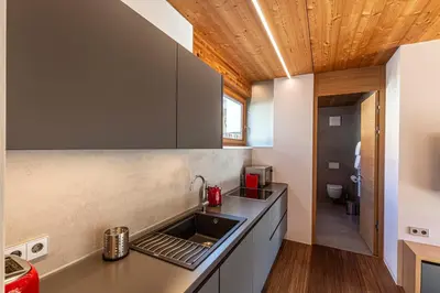 a kitchen with a sink and a counter top at Kronplatz LOFT Bruneck in Brunico