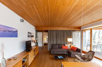 a living room with a couch and a tv at Kronplatz LOFT Bruneck in Brunico