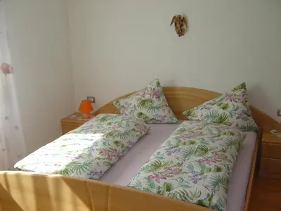 a bed with two pillows on top of it at Appartements Oberleiter in Valdaora