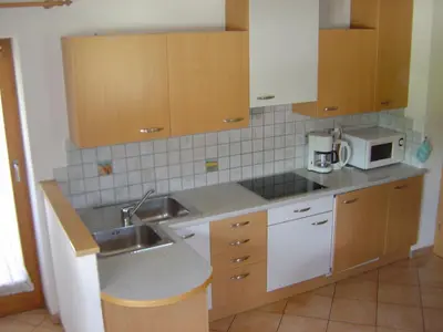 a kitchen with a sink and a microwave at Appartements Oberleiter in Valdaora