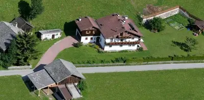 an aerial view of a large house on a hill at Ferienhaus-Grünfelder in Luson