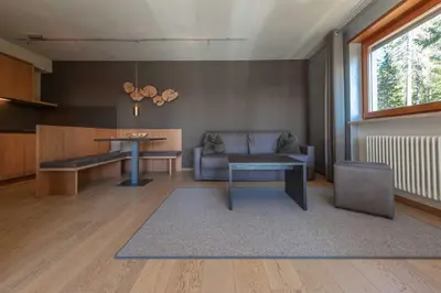 a living room with a table and a couch at Josef Mountain Resort in Avelengo