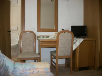 a room with a desk with a computer and two chairs at Agri-park Casa Miramonte in Ronzone
